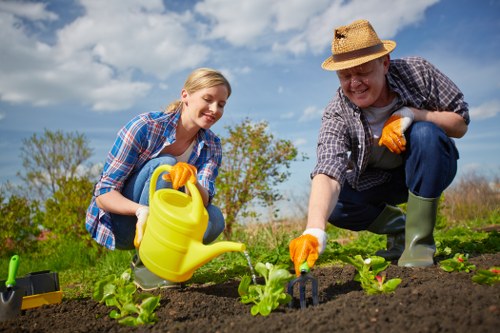 Worker demonstrating accessible gardening techniques in a Docklands green space